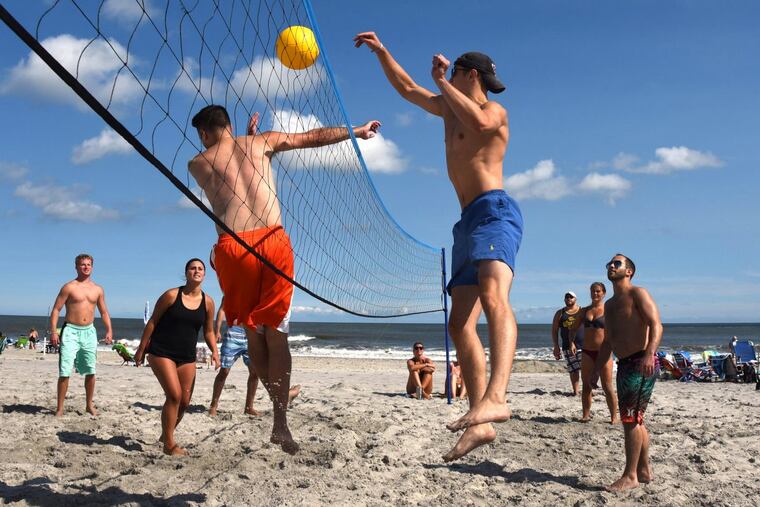 Sharing a house for the weekend, friends from Archbishop Wood and Upper Moreland High Schools play volleyball on the beach in Sea Isle City.
