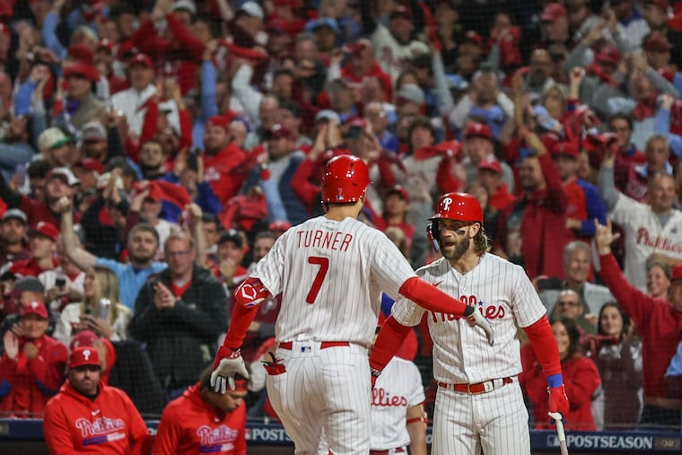Bryce Harper and Trea Turner celebrate Turner's home run in the first inning of Game 2.