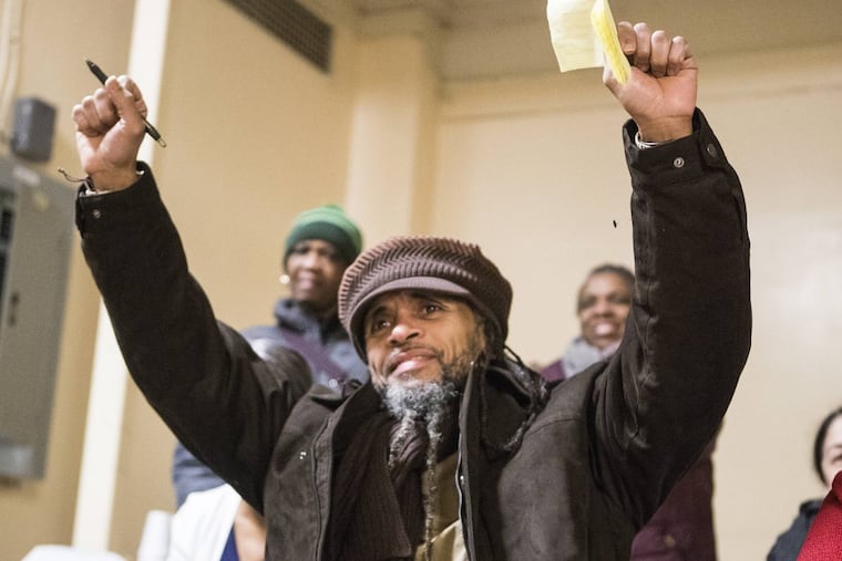 Paroled juvenile lifer Kempis “Ghani” Songster was released from Graterford State Prison Thursday morning. He holds up his arms as he acknowledges the words of friends and relatives at a reception at Calvary Center for Culture and Community on Dec. 28, 2017.