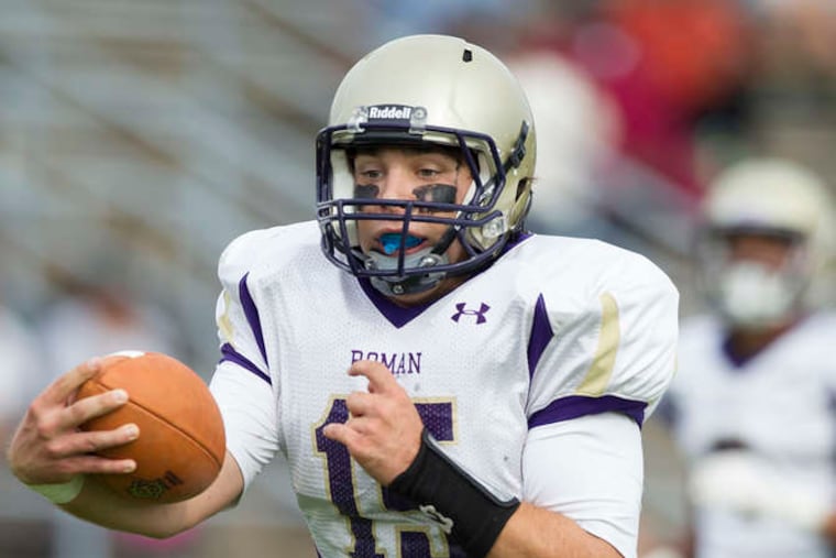 Roman Catholic quarterback Michael Keir scores a touchdown in the second quarter.