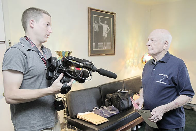 Film maker Daniel Goodman (left) chats with Red Mascara, 92, before filming at Red's Philipsburg home. (Akira Suwa / Staff Photographer)