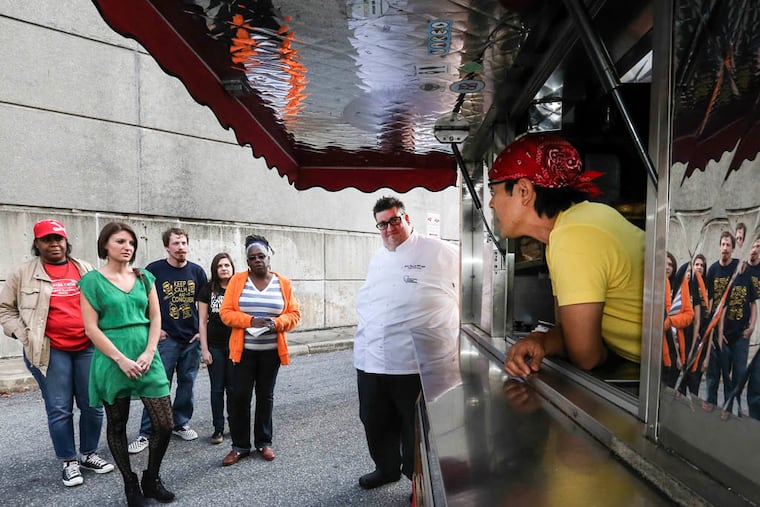 Philadelphia Community College's Chef John Olsen, white coat, teaches how to run a food truck to small group of students who want to be food truck operators. SPOT Burger chef/owner Josh Kim, at right is guest speaker. The only college program of its kind in the country. Wednesday, October 8, 2014. ( Steven M. Falk / Staff Photographer )