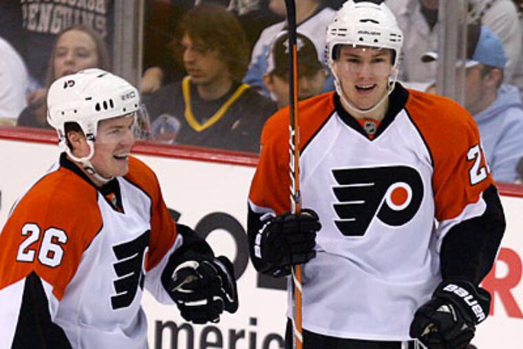 James van Riemsdyk (right) celebrates with Danny Syvret after scoring a goal during the first period. (Gene J. Puskar/AP)
