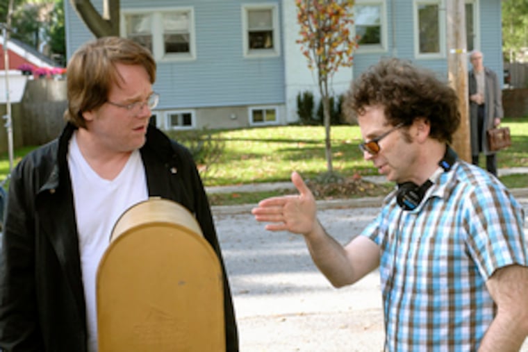 Charlie Kaufman (right), in his role as director, points out the curvy way to surreality to actor Philip Seymour Hoffman.