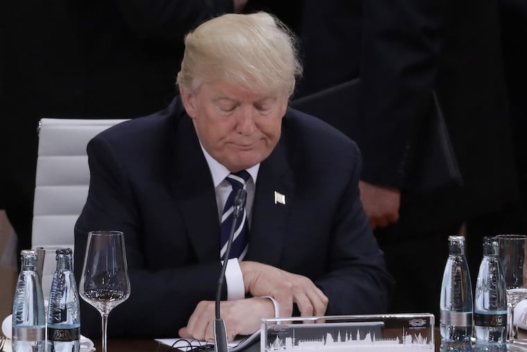 President Trump waits for the beginning of a working session during the G-20 summit in Hamburg on July 7.