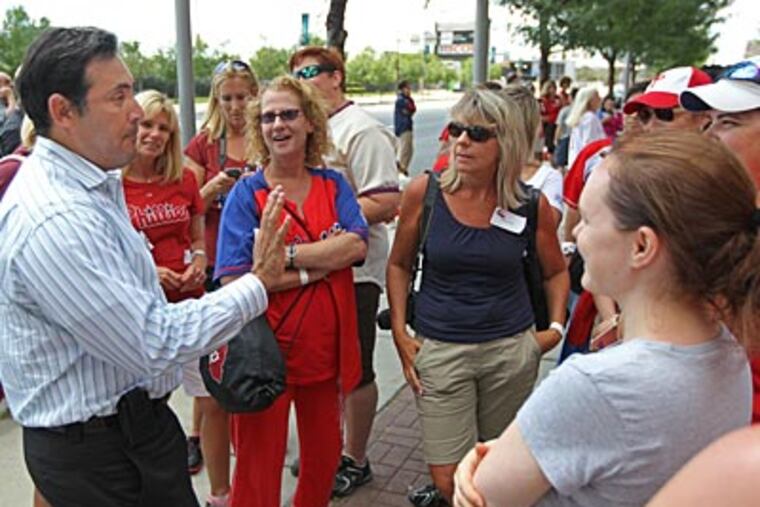 Ruben Amaro Jr. chats with Phillies fans outside of Citizens Bank Park after the building was evacuated. (Michael Bryant/Staff Photographer)
