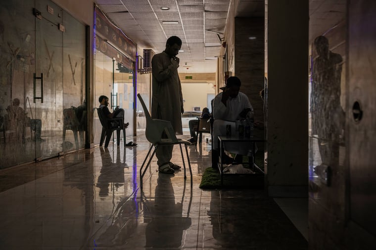 Masood, from Pakistan, with a friend in Dubai. He is the brother-in-law and cousin of Muzaffar Ali Ghulam, who was killed when shrapnel struck his car.