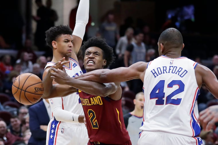 The Cavaliers' Collin Sexton squeezes between 76ers Matisse Thybulle and Al Horford in the second half.