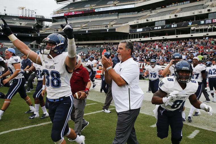 Villanova head coach Mark Ferrante (center) celebrates his teams 19-17 win over Temple with players defensive back Chucky Smith (left) and running back D'Andre Pollard on Saturday, September 1, 2018. YONG KIM / Staff Photographer