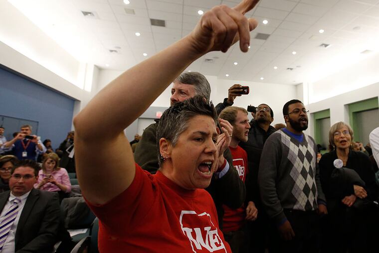 Opponents of charter schools protest before being escorted from the School Reform Commission meeting. YONG KIM / Staff Photographer
