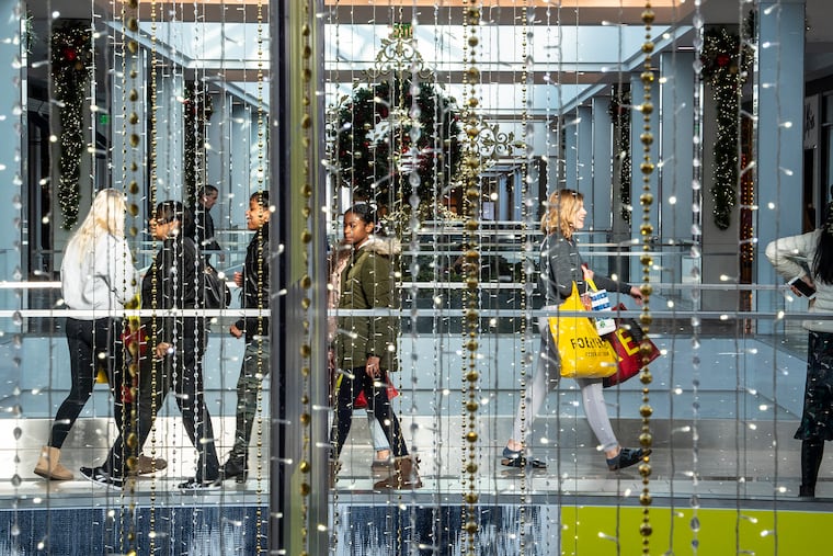 Shoppers walk along the floors of the King of Prussia Mall on Friday.