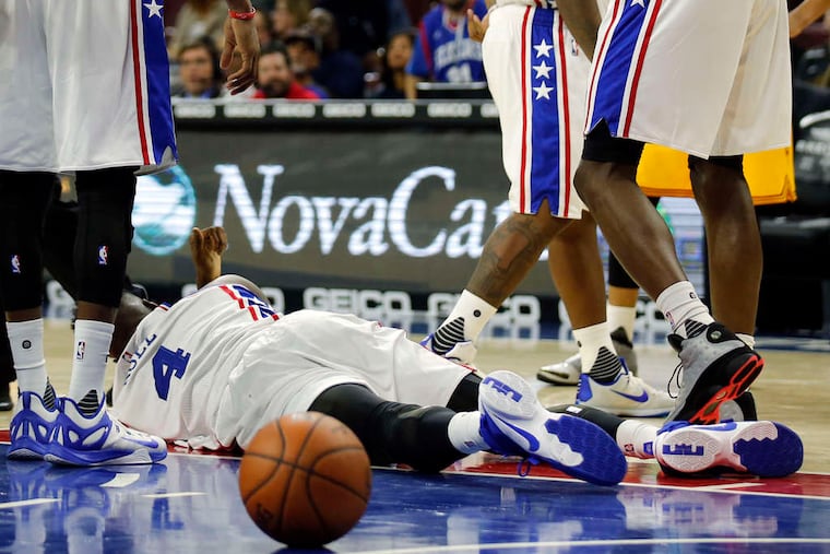 Nerlens Noel lies on the court after being fouled under the basket in the third quarter of Thursday's preseason game against Cleveland. Coach Brett Brown said Noel would not play Saturday against the Nets.