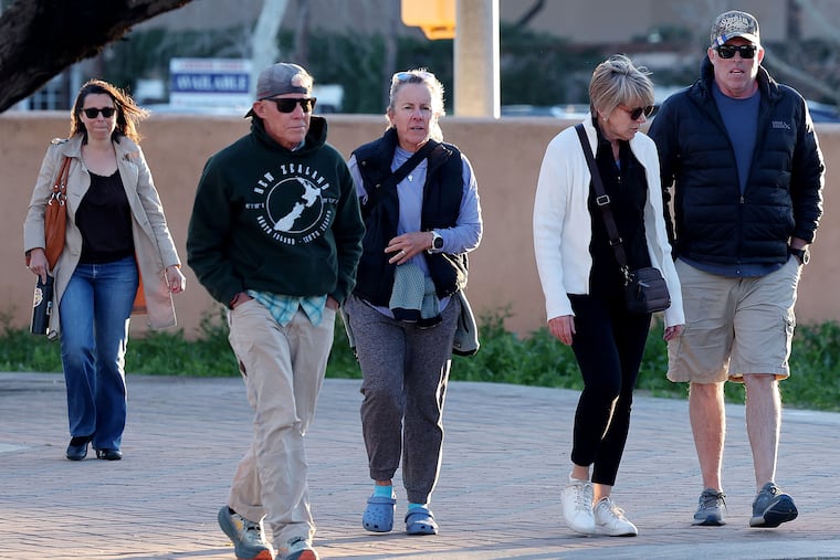 A group of people walk up to St. Philip's in the Hills Episcopal Church in Tucson, Ariz., on Wednesday to attend the candlelight service for Nancy Guthrie, the 84-year-old mother of NBC "Today" show host Savannah Guthrie.