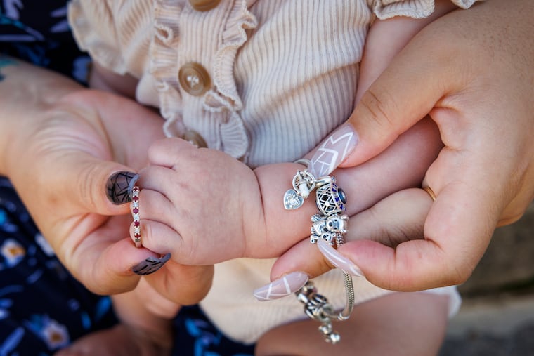 Xiaoming Baldwin's “push presents” — a ring and charms for a bracelet.