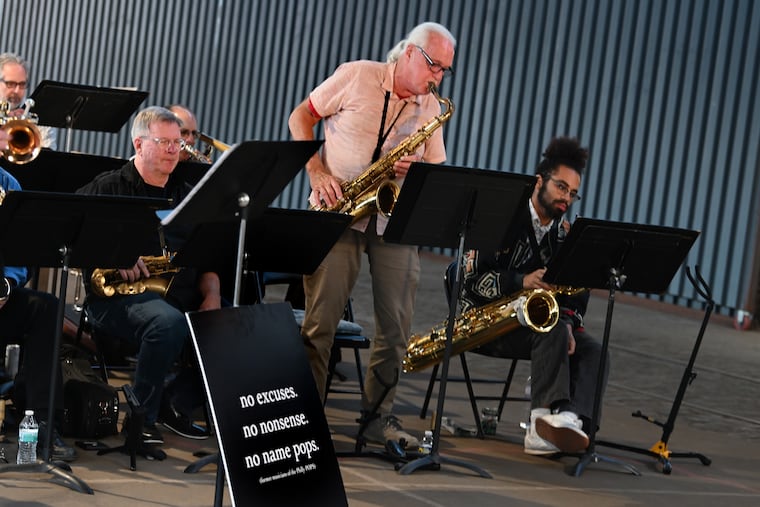 Joe Smith on tenor saxophone stands for a solo as the “No Name Pops” performs a free big band concert on the Cherry Street Pier on May 25, 2023. The ensemble is made up of former Philly Pops musicians.