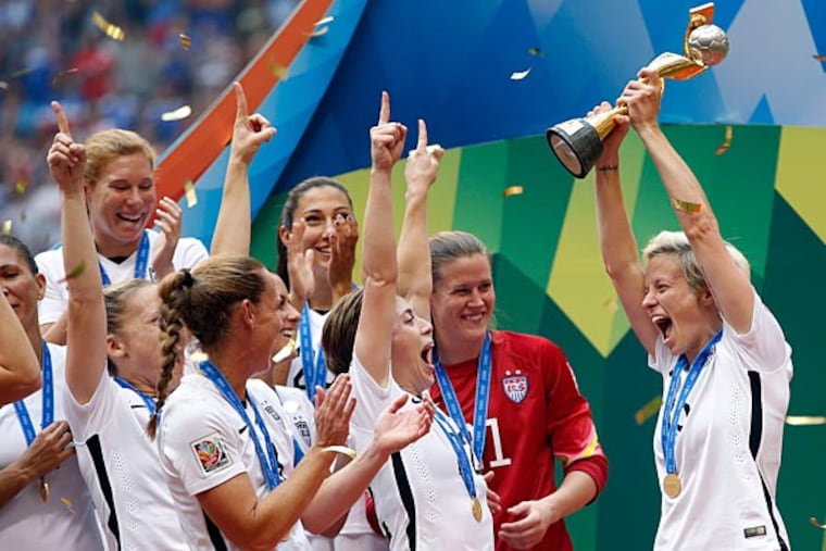 United States midfielder Megan Rapinoe (15) celebrates with teammates after defeating Japan in the final of the FIFA 2015 Women's World Cup at BC Place Stadium. United States won 5-2. (Michael Chow/USA Today)