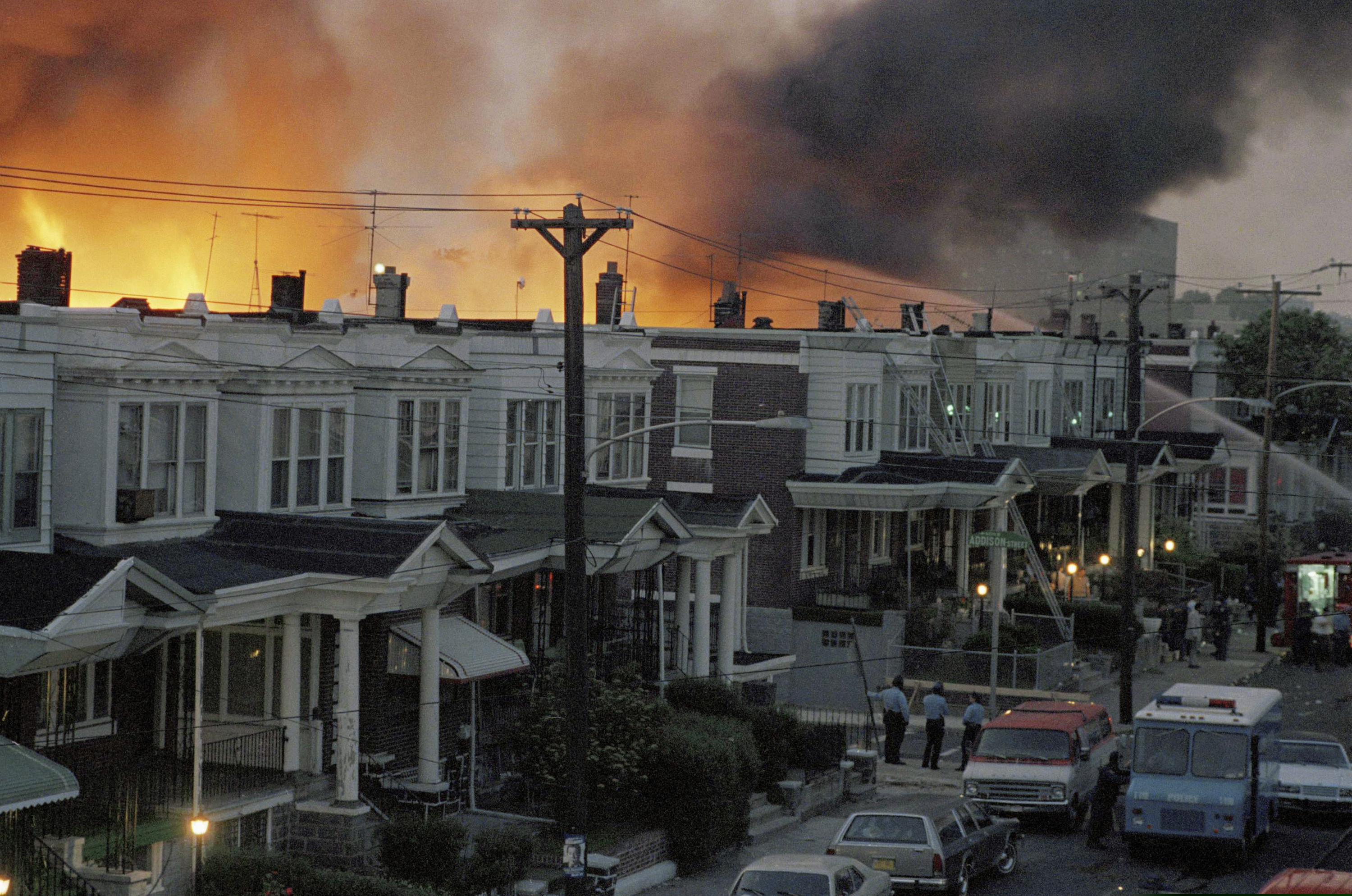 Scores of rowhouses burn in a fire in the West Philadelphia neighborhood where police dropped a bomb on MOVE's home on May 13, 1985.