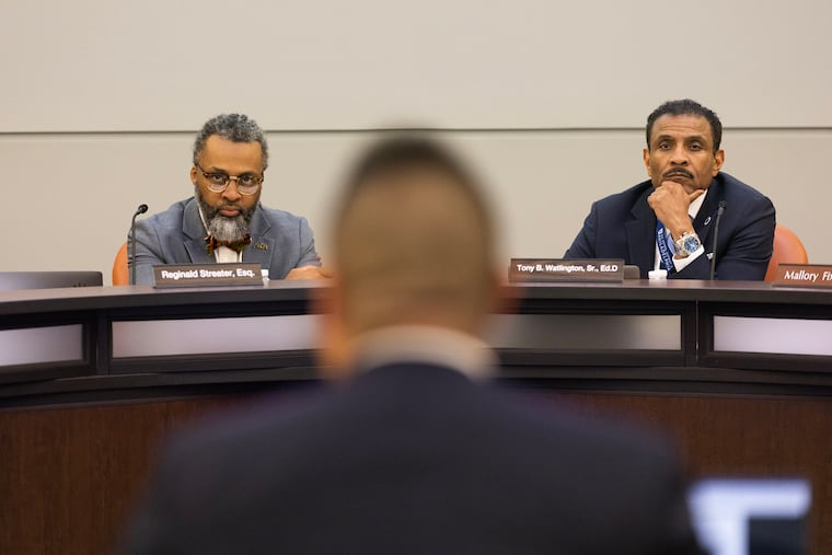 Philadelphia School Board President Reginald Streater (left) and Superintendent Tony Watlington (right) listen to a presentation during a school board meeting on Aug. 17, 2023.