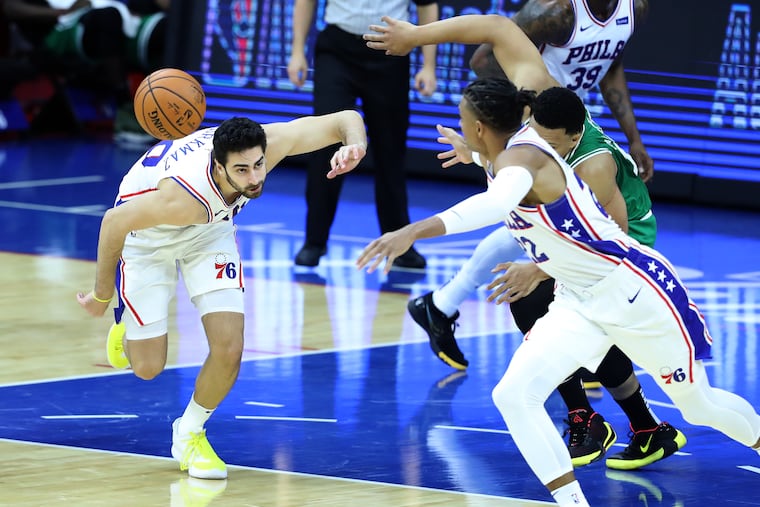 Furkan Korkmaz, left, and Matisse Thybulle of the Sixers go after a loose ball as they come up with a steal against the Celtics during the second half of a preseason game at the Wells Fargo Center on Tuesday.