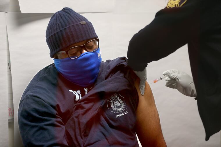 Airport Rescue Paramedic Raufail Mallard receives his first dose of the Moderna COVID-19 vaccine at the headquarters of the Philadelphia Fire Department in Philadelphia, Pa. on January 6, 2021.
