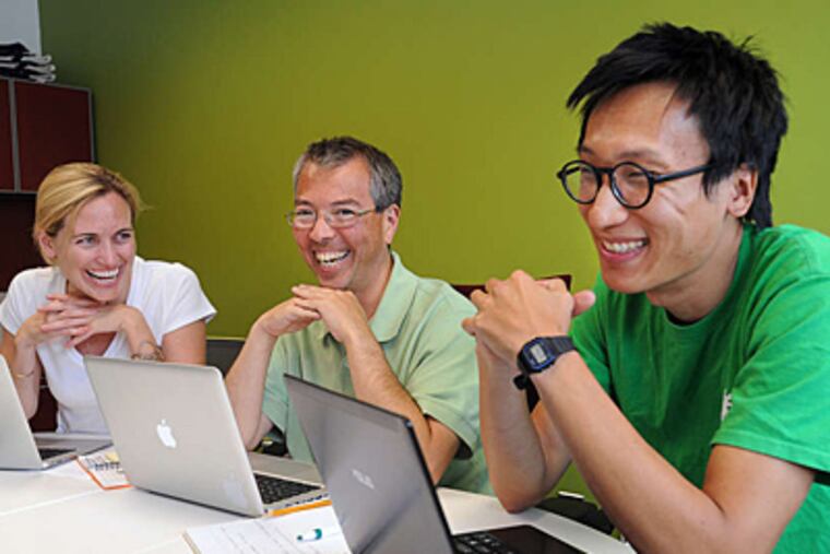 Drexel law professor Karl Okamoto (center) with members of the ApprenNet team, Emily Foote (left) and Paul Tzen. (Sharon Gekoski-Kimmel/Staff)