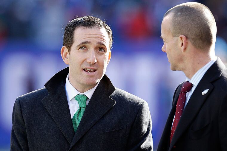 Howie Roseman speaks with team president Don Smolensk.