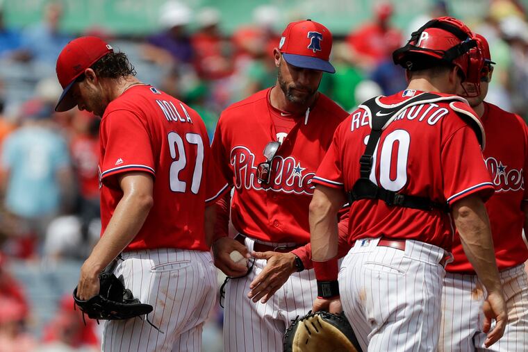 Phillies pitcher Aaron Nola walks off the mound after getting replaced by Manager Gabe Kapler.