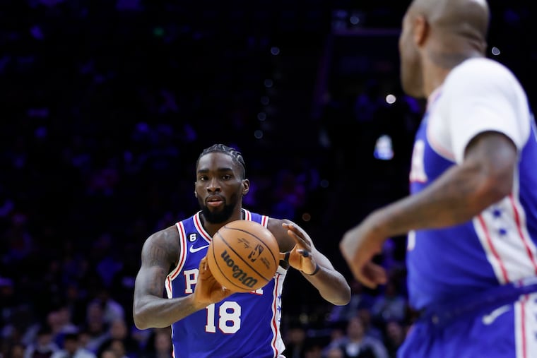 Sixers guard Shake Milton passes to teammate forward P.J. Tucker in a game at the Wells Fargo Center.