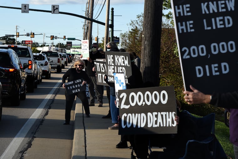 Activists with the group Progress PA demonstrate on Route 19 in Wexford, Pa., on Sept. 18.