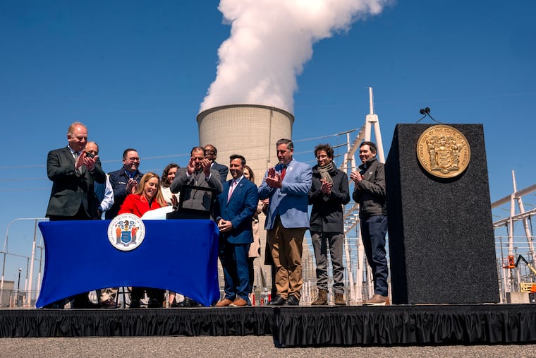 With a cooling tower as a backdrop, Gov. Mikie Sherrill signs a bill allowing new nuclear projects in the state at the PSEG Salem and Hope Creek Nuclear Generating Station in Lower Alloways Creek, N.J. Wednesday, April 8, 2026.