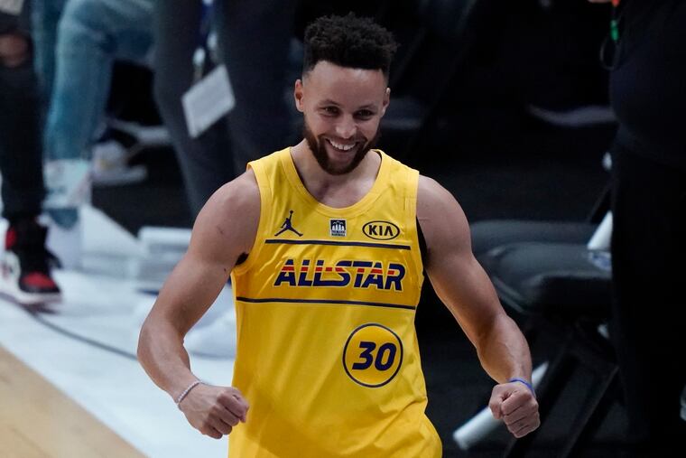 Golden State Warriors guard Stephen Curry celebrates after winning the 3-point contest at basketball's NBA All-Star Game in Atlanta.