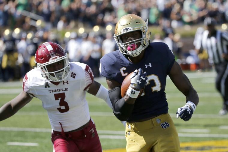 Notre Dame running back Josh Adams (33) sprints to the end zone for a touchdown past Temple defensive back Sean Chandler (3) and Mike Jones (10) during the first half Sept. 2 in South Bend, Ind.
