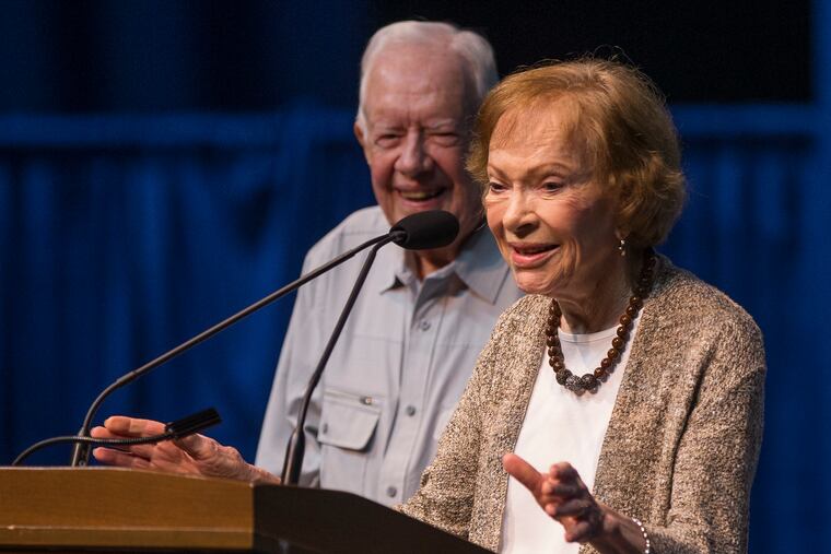 Former first lady Rosalynn Carter speaks next to her husband, former President Jimmy Carter, during the opening ceremony for the Jimmy & Rosalynn Carter Work Project, in 2018. Rosalynn Carter, the closest adviser to Jimmy Carter during his one term as U.S. president and their four decades thereafter as global humanitarians, died Sunday. She was 96.