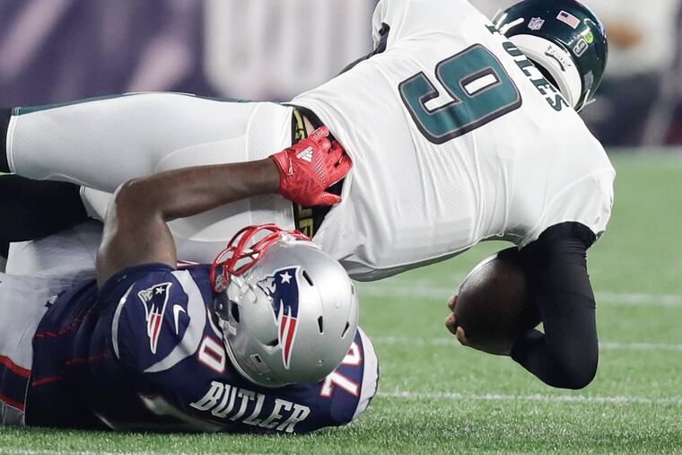 Eagles quarterback Nick Foles gets sacked by Patriots defensive lineman Adam Butler.