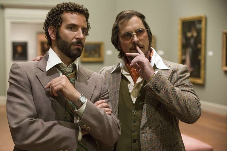 Bradley Cooper, left, and Christian Bale star in "American Hustle."