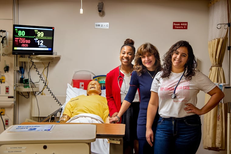 Nursing students Jasmine Jones (left) and Genesis Sanchez (right) with Laura Gitlin, dean of the Drexel University College of Nursing and Health Professions in a clinical simulation room at the school. The college has the largest bachelor program in the three-state region.