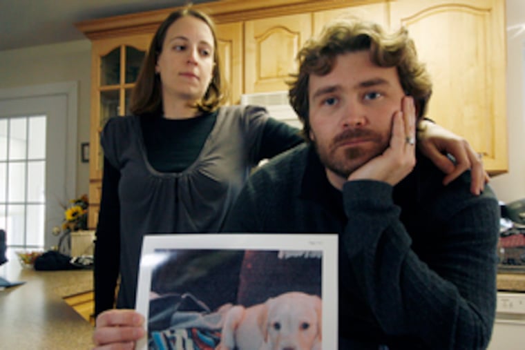 Stephanie and Lewis Ostrander of Upper Township, N.J., with a photo of their labradoodle puppy, Maya, who had canine parvovirus and had to be euthanized in November.