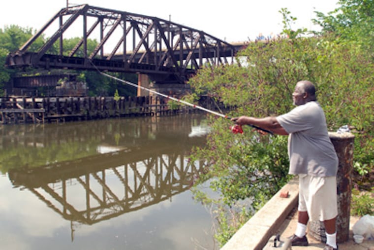 Near Bartram’s Garden, Dennis Randolph casts a line into the Schuylkill near the southern boundary of the so-called DuPont Crescent tract. The two new tracts will help connect this point with Locust Street. (Ron Tarver / Staff Photographer)