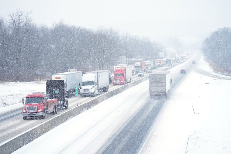 Vehicles slowly move during a storm Tuesday on Interstate 78 in Kutztown, Pa.