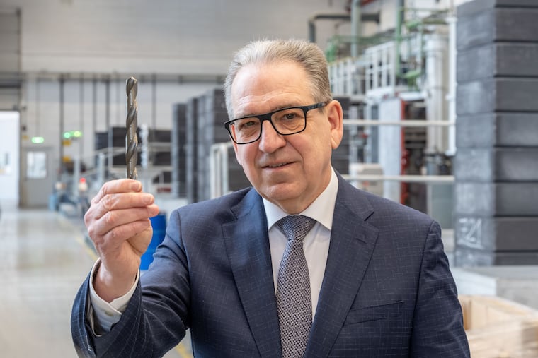 Karlheinz Wex, executive board chairman of Plansee, the Austrian metals company that owns Global Tungsten & Powders, which processes 10% of the world's tungsten production at its plant in Towanda, Pa. He is holding a tungsten carbide drill bit, tough enough to make holes in hardened steel, at Plansee headquarters in Reuss, Austria, January 2026.