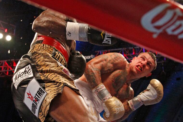 Gabriel Rosado ducks after a Peter Quillin punch. (Ron Cortes/Staff Photographer)