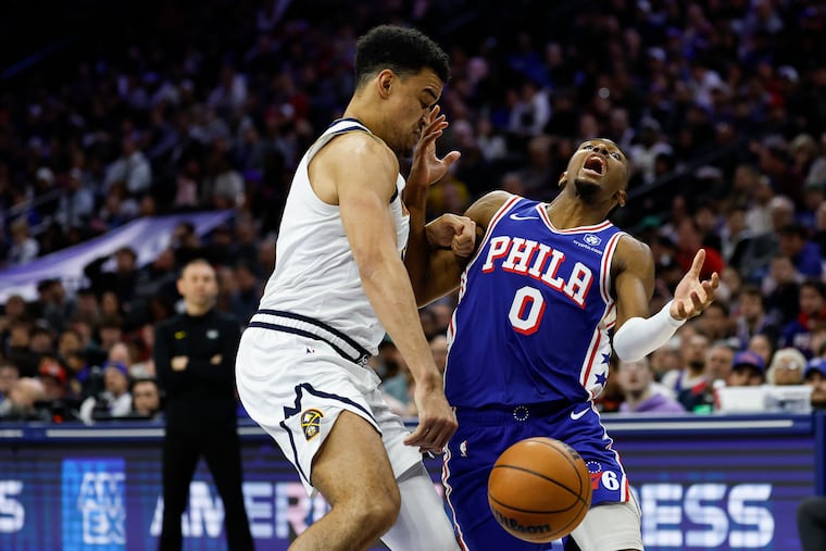 Sixers guard Tyrese Maxey loses the basketball while being defended Nuggets forward Spencer Jones during the second quarter on Monday.