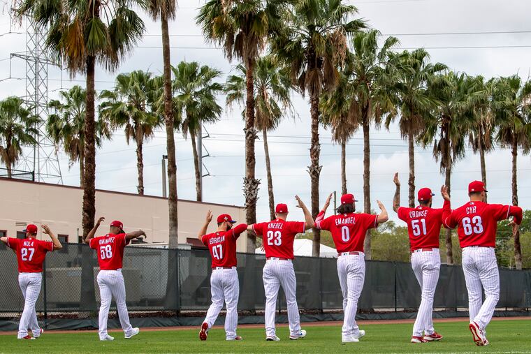 Phillies pitchers warmup during spring training workouts at BayCare Ballpark in Clearwater, Fla., on Wednesday.
