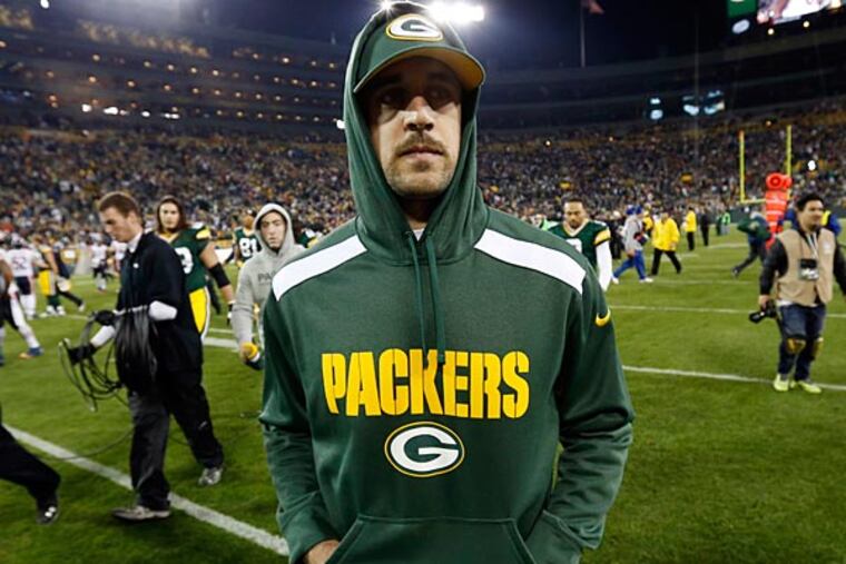 Green Bay Packers' Aaron Rodgers walks off the field after an NFL football game against the Chicago Bears Monday, Nov. 4, 2013, in Green Bay, Wis. Rodgers was injured in the first half of the game. The Bears won 27-20. (AP Photo/Mike Roemer)