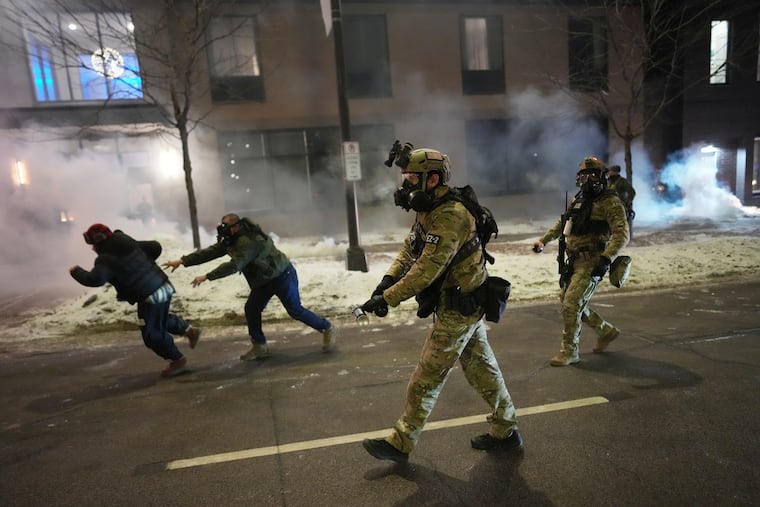 Federal agents in Minneapolis use tear gas to clear demonstrators during a protest on Sunday in response to immigration enforcement operations in the city.