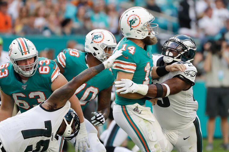 Eagles defensive ends Vinny Curry and Brandon Graham go after Miami Dolphins quarterback Ryan Fitzpatrick on Sunday.