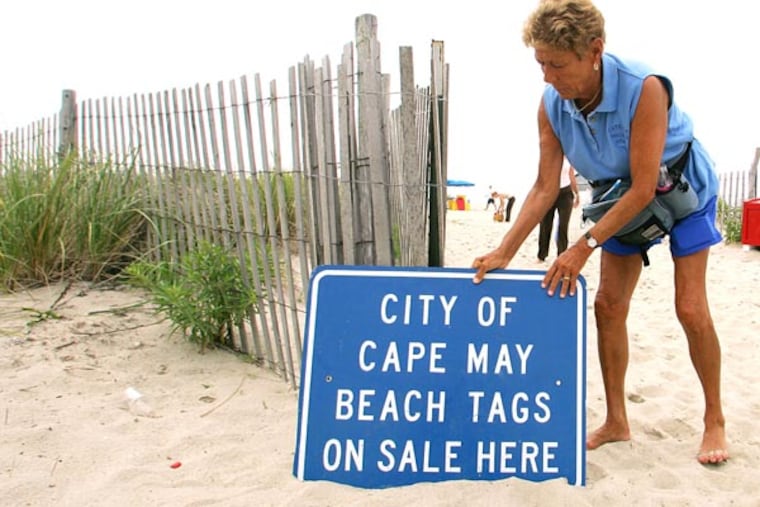 Jackie Rotz puts her beach tag sign outside her gate where she sells and validates beach tags in Cape May, N.J. in 2005. For summer 2024, Cape May is unveiling a new digital cashless option to buying and displaying beach tags at the beach.