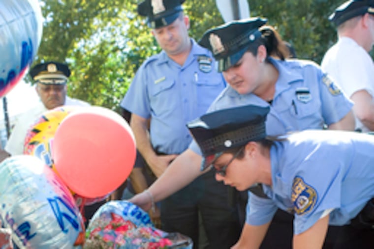 Police pay tribute yesterday to Officer Isabel Nazario at memorial near where her patrol car was hit Friday.