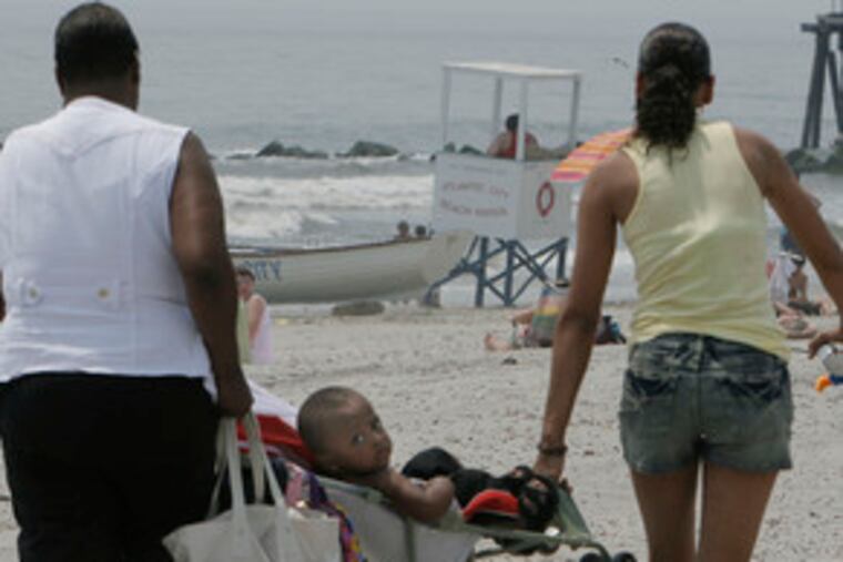 Maquez Corbin gets a ride to the Atlantic City beach from his grandmother Joyce Rivera and his mother, Tiffany Corbin (right). They were visiting from North Bergen, N.J.