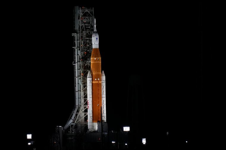 NASA's new moon rocket sits on Launch Pad 39-B hours ahead of a planned launch at the Kennedy Space Center on Saturday.